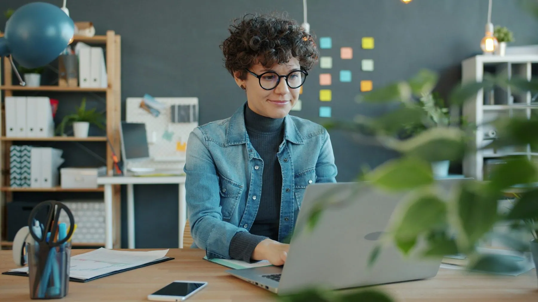 young successful businesswoman working with laptop computer in creative office focused on job. People and modern busines