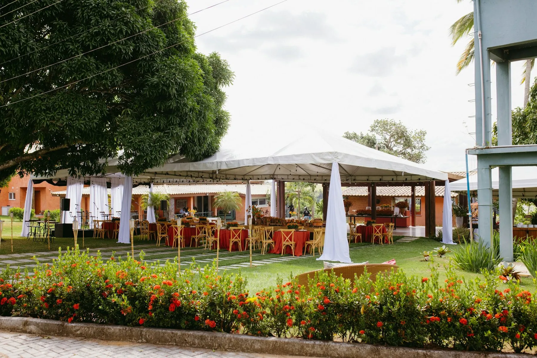 Outdoor event tent with tables and chairs on green grass