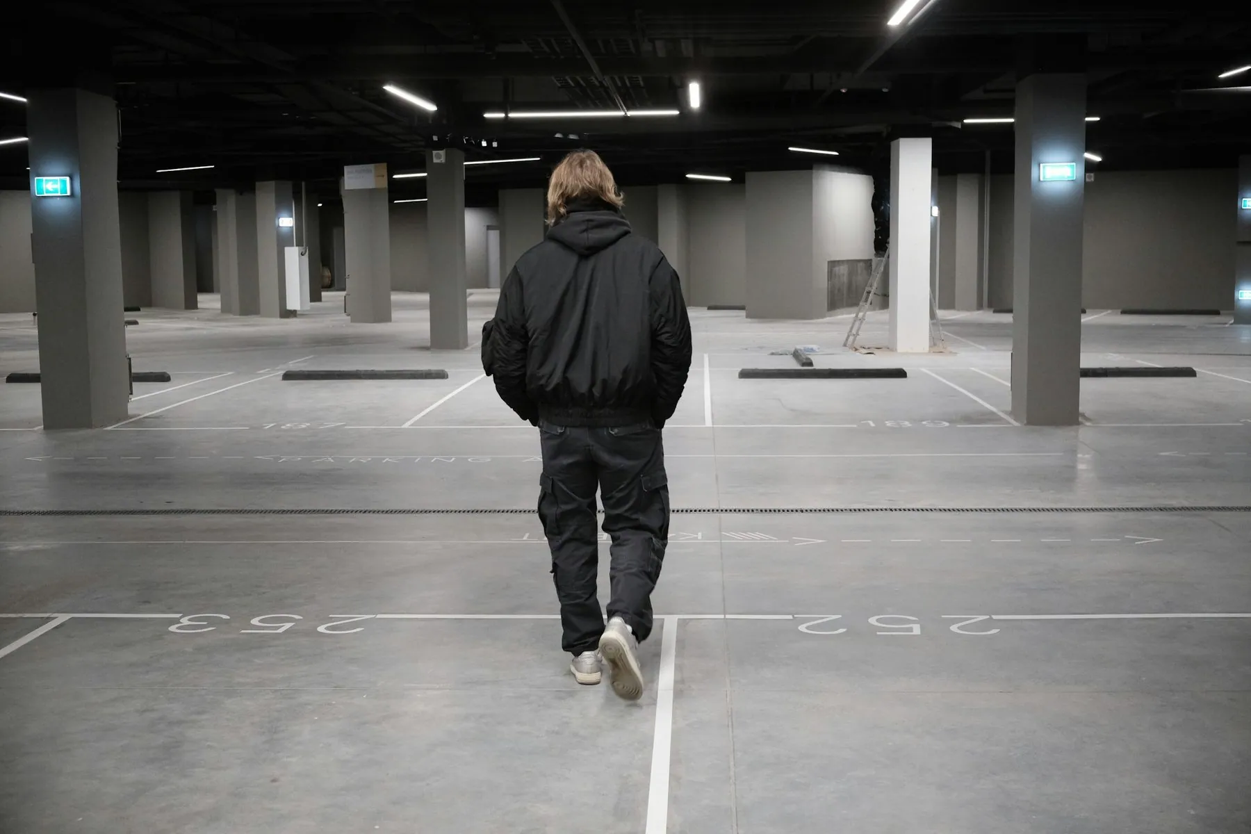 Person walking in an empty parking garage